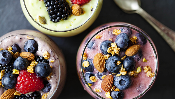 Bowls with smoothie with berries and nuts topping
