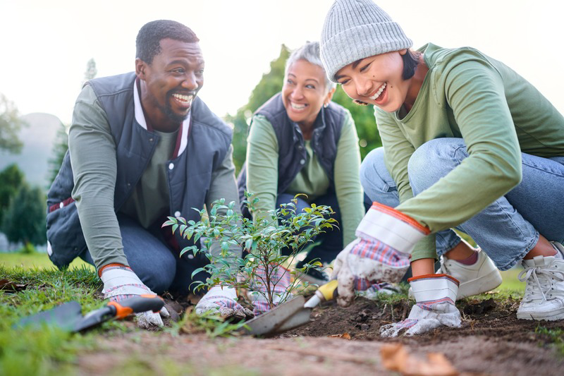 Friends smiling while gardening outside
