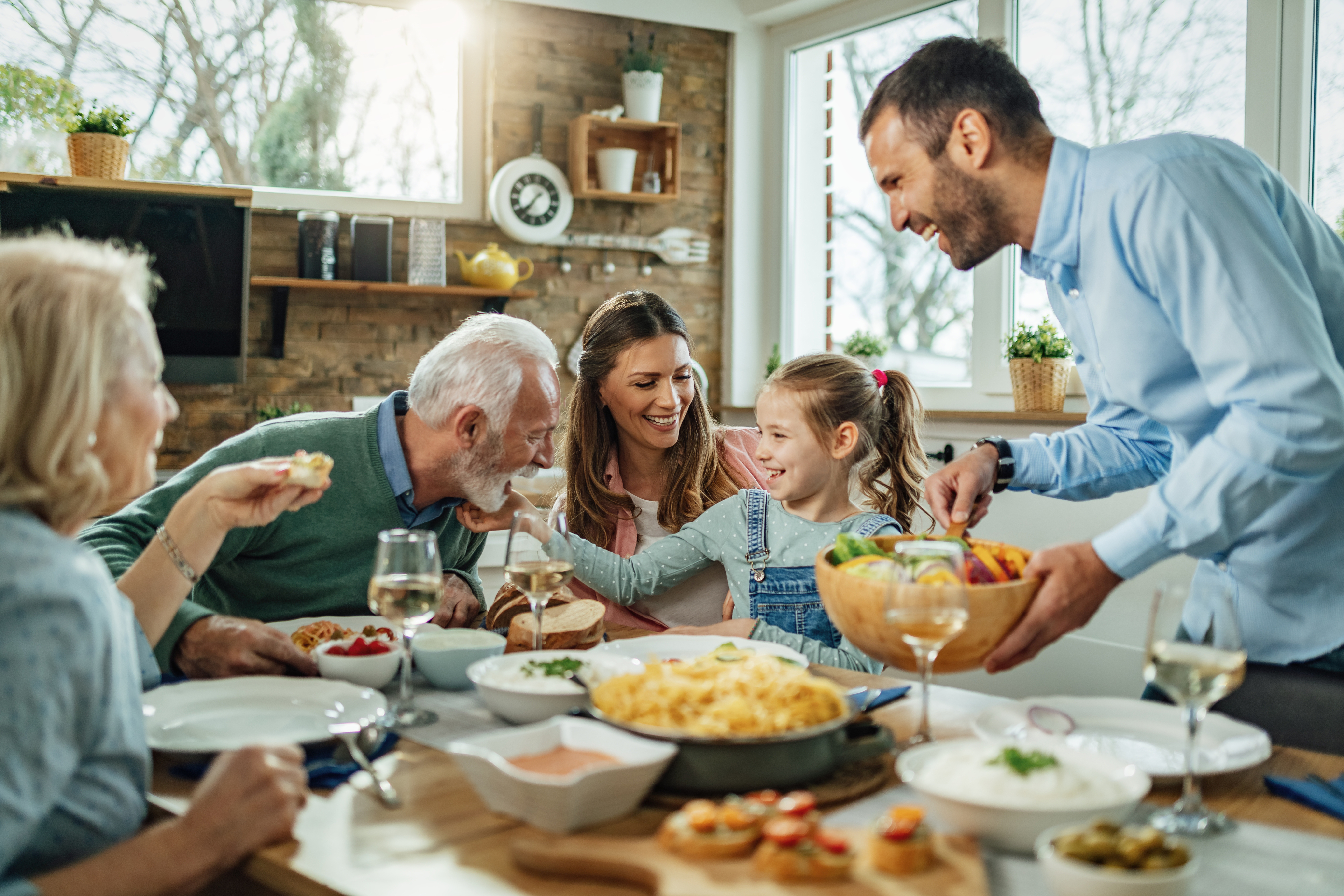 Five family members enjoy a meal together.