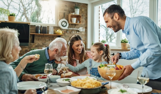 Five family members enjoy a meal together.