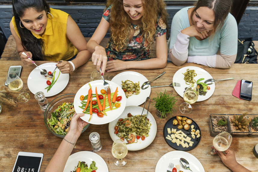 Smiling group of people enjoying a healthy meal
together