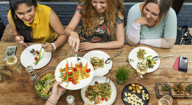 Smiling group of people enjoying a healthy meal together